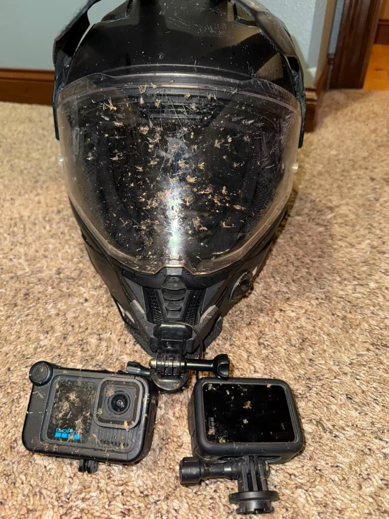 Bug-splattered adventure helmet with dual GoPro mounts after a long day
