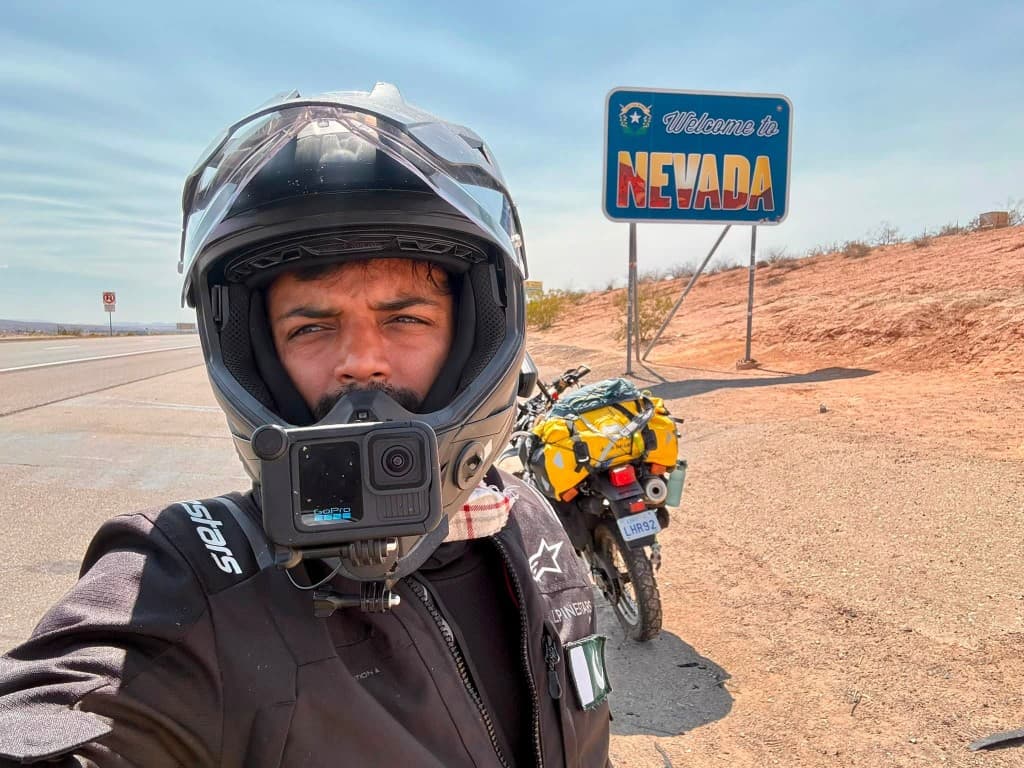 Nevada welcome sign with adventure motorcycle