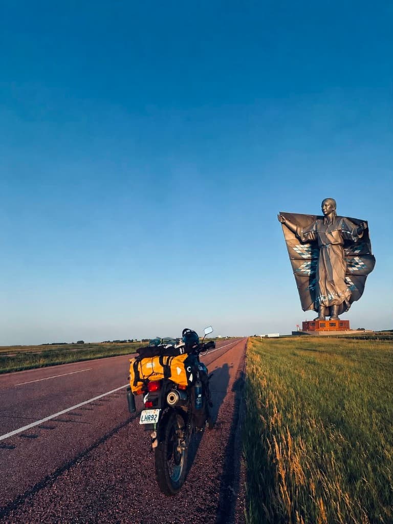 Dignity statue overlooking the Missouri River with loaded motorcycle