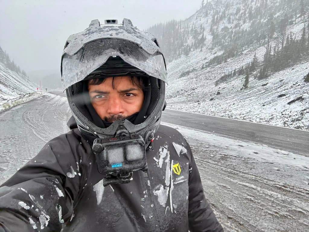 Snowstorm selfie on a mountain pass with frost-covered GoPro