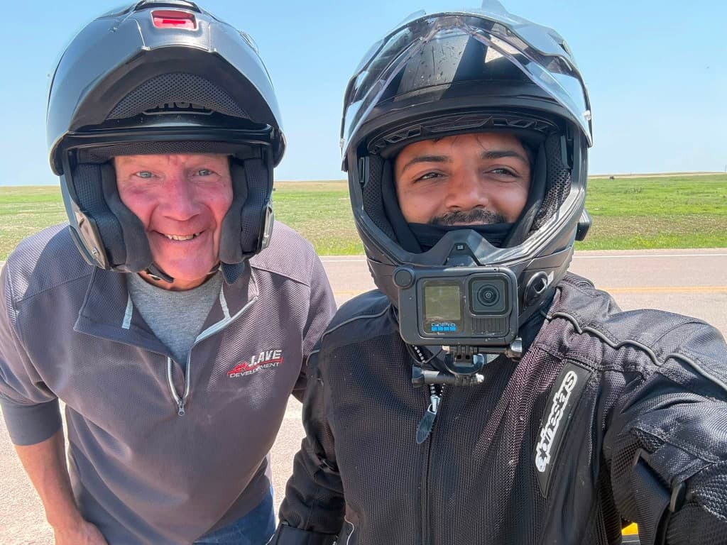 Selfie with a riding companion on an open prairie road