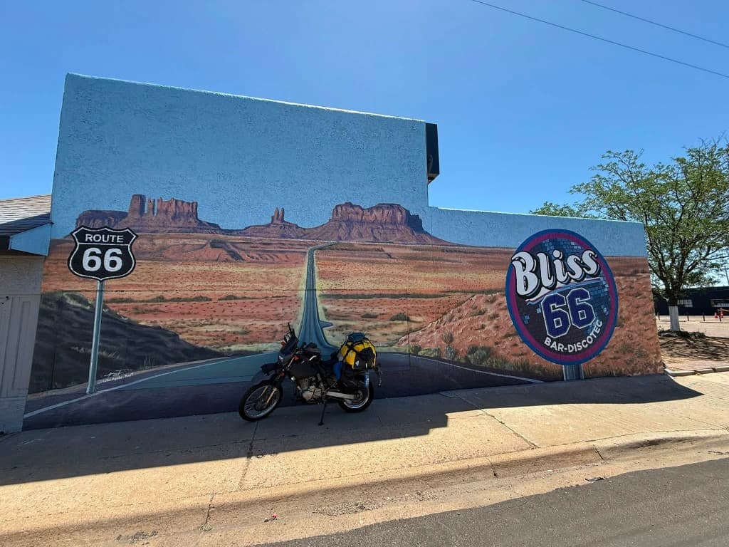 Route 66 mural with loaded adventure motorcycle