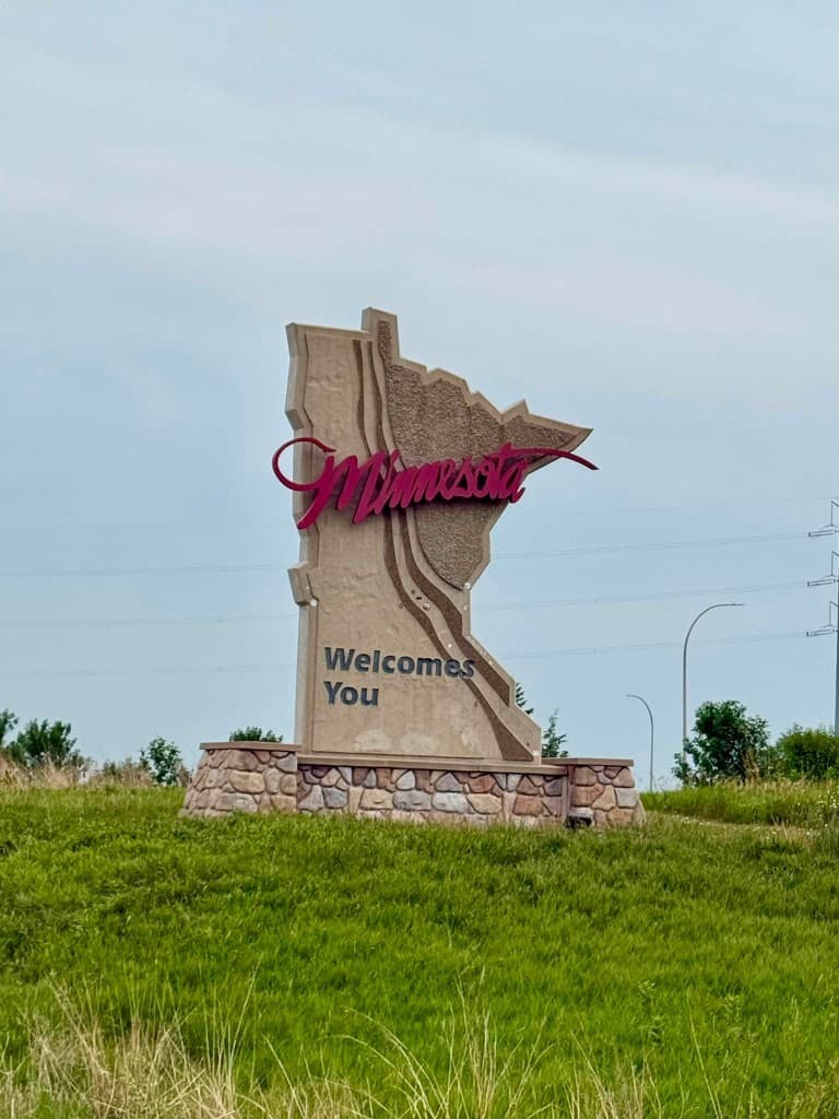 Minnesota welcome monument on a grassy hill