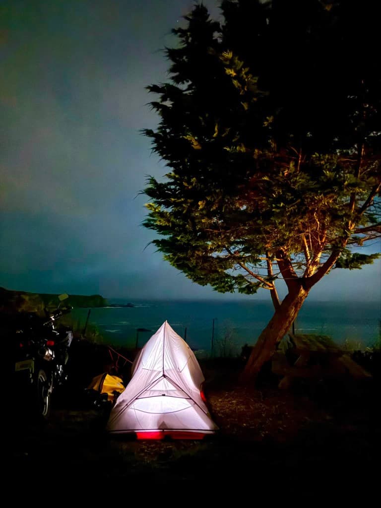 Night coastal campsite overlooking the ocean