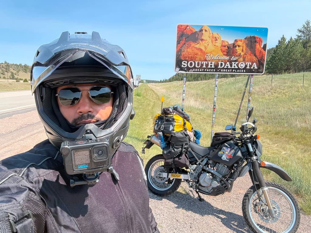 South Dakota welcome sign with adventure motorcycle